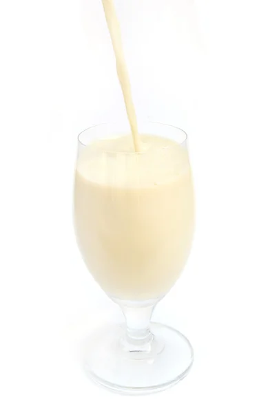 Pouring soybean milk to wine glass — Stock Photo, Image