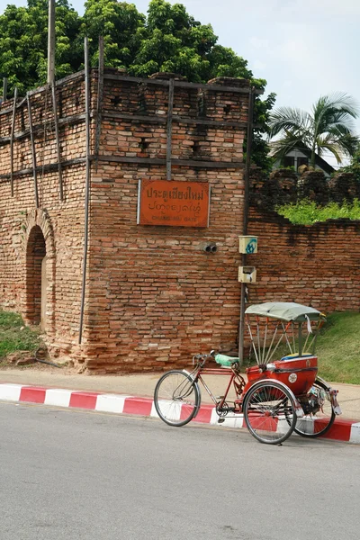 Un triciclo y una antigua muralla de Chiang Mai, Tailandia —  Fotos de Stock