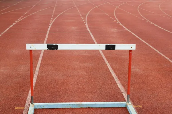 A hurdles on red running tracks — Stock Photo, Image