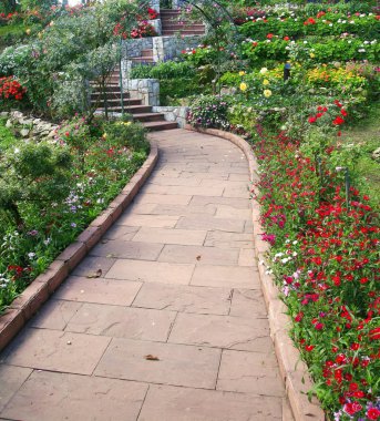 stone walkway in flower garden clipart