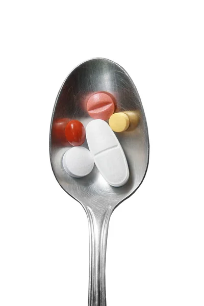 Spoon of capsules and pills — Stock Photo, Image