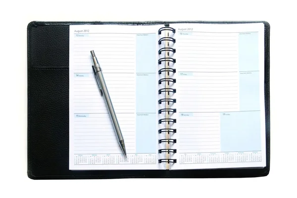 Notebook e caneta sobre fundo branco — Fotografia de Stock