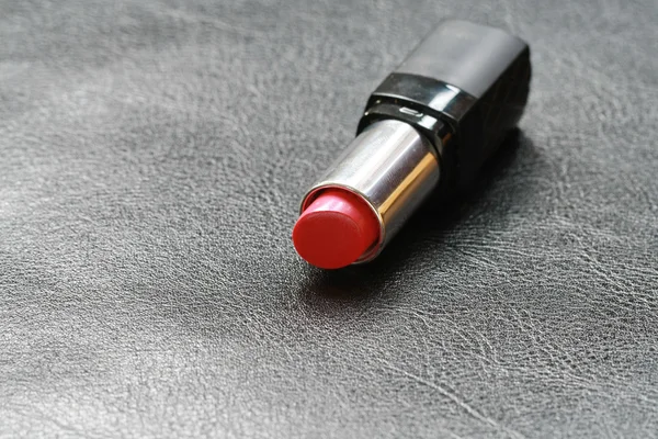 A lipstick on leather floor — Stock Photo, Image