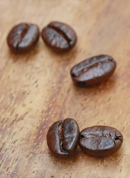 Semente de café na mesa de madeira — Fotografia de Stock