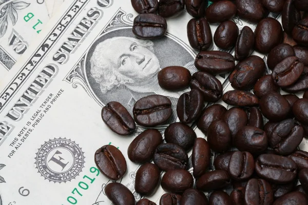 Background of dollar bills and coffee beans — Stock Photo, Image