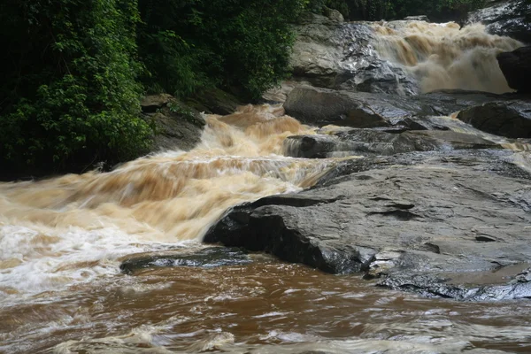 Cataratta dopo la pioggia, fiume rosso — Foto Stock