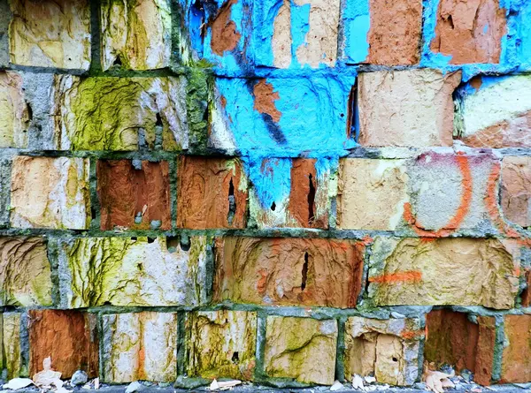 Old brick wall with colorful graffiti — Stock Photo, Image