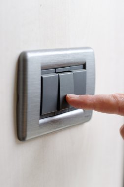 Finger pressing light switch, turning it on or off clipart
