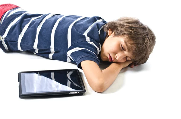 Criança dormindo ao lado do tablet pc — Fotografia de Stock