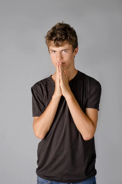 Cute teenage boy with hands on his mouth — Stock Photo, Image