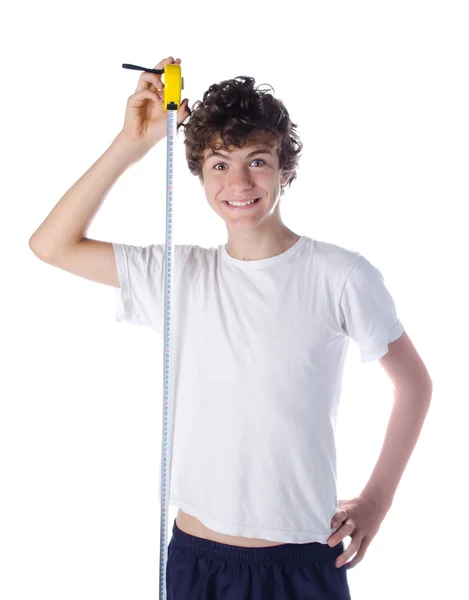 Happy boy measuring his own height — Stock Photo, Image