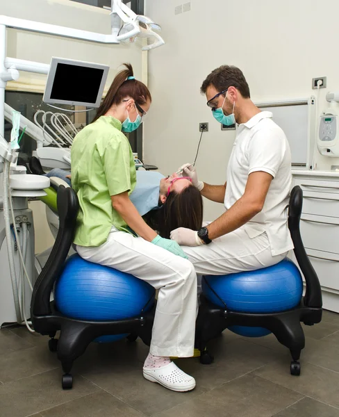Dentist, assistant and patient in dental clinic — Stock Photo, Image