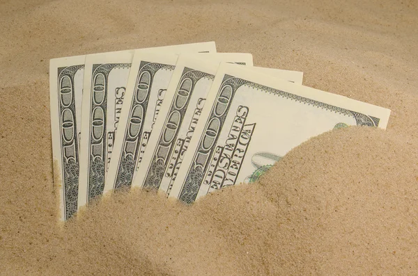 Dollars in sand — Stock Photo, Image