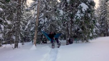 Hiker Drinking Cofee, Relaxing, Lying In Hammock In Winter Forest