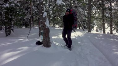 Hiker With Snowshoes Walking In Deep Snow