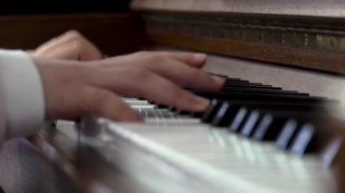 Child playing piano. Close up