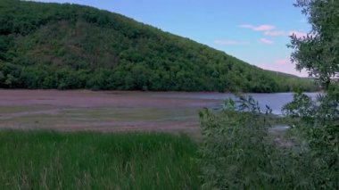 Landscape of a lake shore with low water due to drought