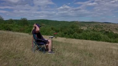 Artist with practice pads and headsets in summer meadow