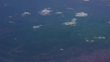 Aerial view from the airplane porthole over clouds
