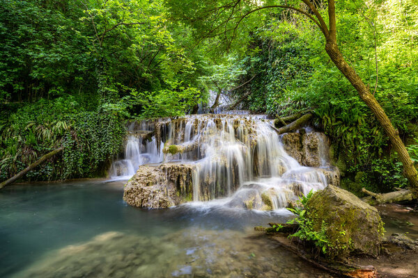 Amazing spring view of a beautiful waterfall in green forest, Krushuna falls, Balkan Mountains, Bulgaria