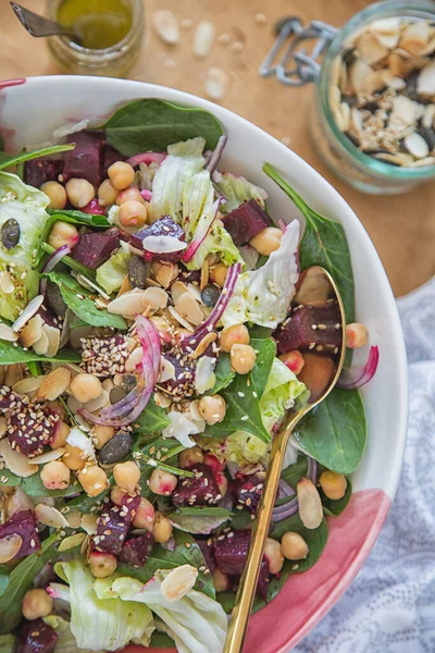 A healthy and fit vegetable lunch or dinner. Salad with chickpeas and baked beetroot. Healthy comfort food.