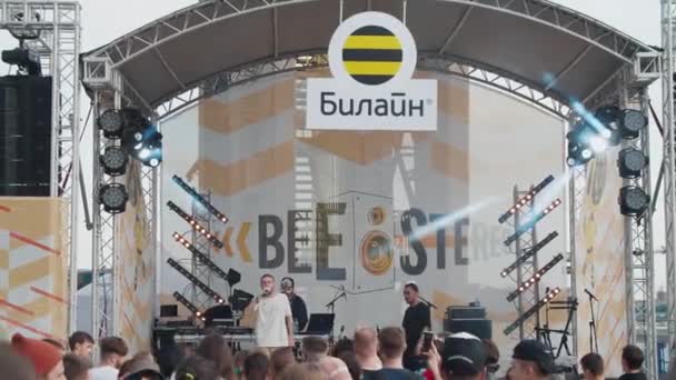 Młodzi fani tańczą przed sceną, ciesząc się muzyką na Letnim Festiwalu Muzycznym Stereoleto, Sankt Petersburg, Sevkabel 2020. Impreza, letnie wibracje, przyjaźń, młodzież — Wideo stockowe