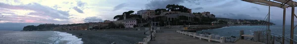 180 degree view of the sunset on the Ligurian beaches of Celle Ligure photographed from the pier — стокове фото