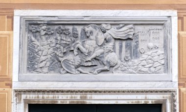 a stone capital over the door depicting the Catholic myth of St. George defeating the dragon. High quality photo