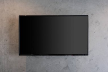 Oturma odasının gri duvarlı, geniş ekran, içinde sıcak ampuller olan bir televizyon. Modern dekorasyon binası kavramının çağdaş eğlence tasarımının mutlu tasarımı.