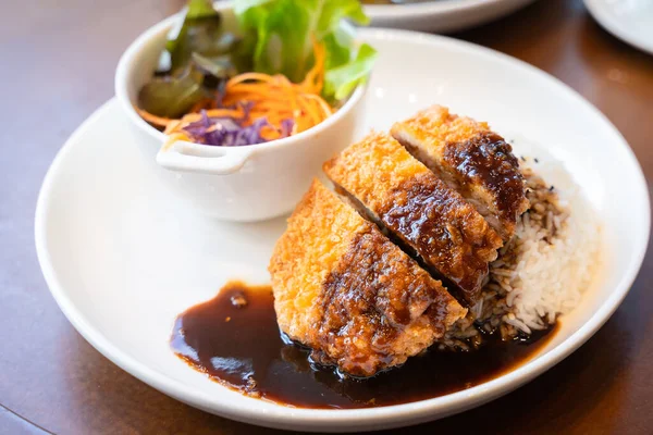 Tonkatsu Pork cutlet top on rice favorite delicious food Japanese that consists of a breaded, deep-fried pork cutlet with gravy Teriyaki sauce juicy. Concept popular national simple food.