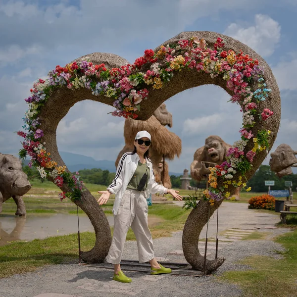 Asian women happy with animal straw puppet at the Huay Tueng Tao Park is the name of a public place for people to relax and attraction in Chiang Mai, Thailand. Rest on vacation.