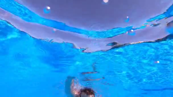 Handsome Young Man Beard Swims Underwater Bottom View Man Floats Clip video