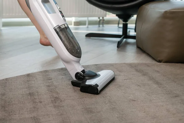 Home cleaning in the apartment with a vacuum cleaner. Carpet cleaning with a vacuum cleaner.