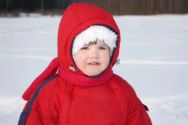 Little serious girl stands near forest at winter and looks into — Stock Photo, Image