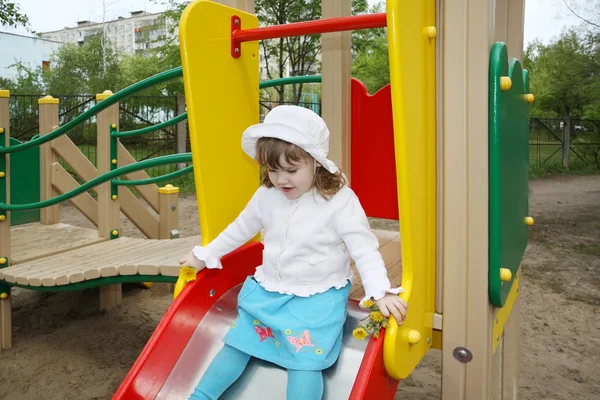 Cute little girl wearing white blouse prepares for rolling at sl — Stock Photo, Image