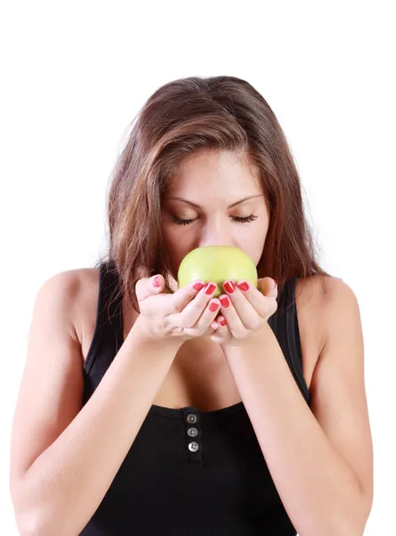 Beautiful brunette girl with closed eyes sniffs green apple isol — Stock Photo, Image