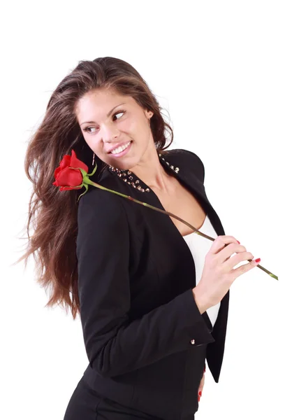 Smiling woman with flying hair holds rose on her shoulder and lo — Stock Photo, Image
