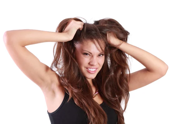 Young angry woman tears her hair and looks at camera isolated on Stock Image