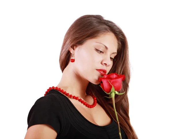 Pensive beautiful woman looks at red rose isolated on white back Royalty Free Stock Photos