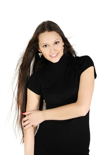 Beautiful brunette girl wearing black dress smiles in white stud — Stock Photo, Image