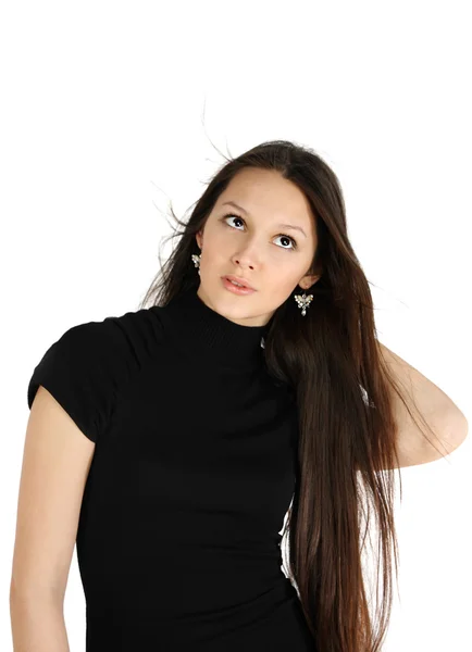 Beautiful brunette girl wearing black dress looks up and dreams — Stock Photo, Image