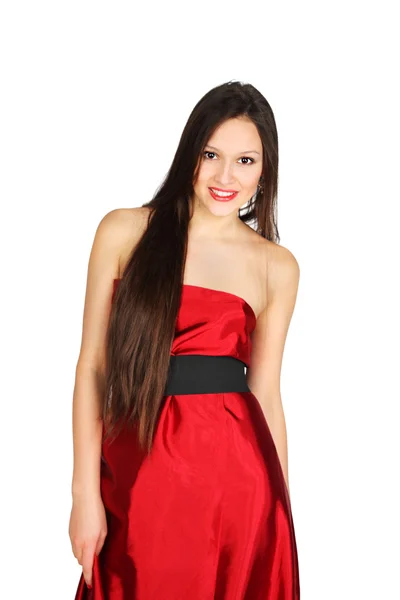 Beautiful smiling girl wearing long red dress stands isolated on — Stock Photo, Image