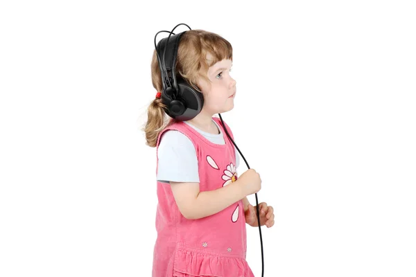 Little girl in big headphones looks up isolated on white backgro — Stock Photo, Image