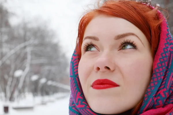 Pretty happy girl in red kerchief looks up outdoor at winter day — Stock Photo, Image