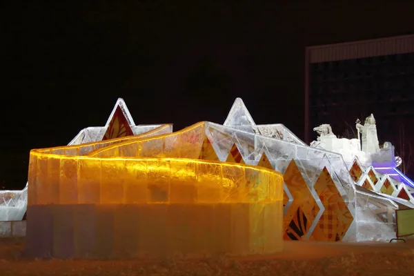 PERM, RUSSIA - JAN 11, 2014: Illuminated orange ice slide in Ice — Stock Photo, Image