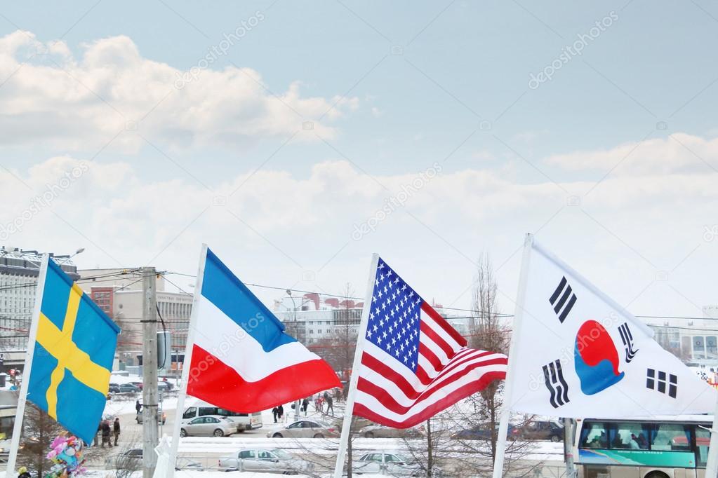 Flags of Sweden, Luxembourg, USA, South Korea on wind at winter 