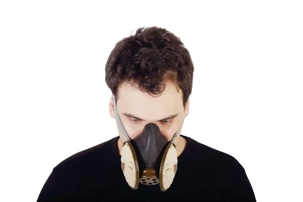 Young handsome man in black shirt and respirator looks down in s — Stock Photo, Image