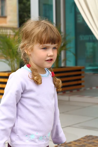 Portrait of little girl with two braids in summer cafe — Stock Photo, Image