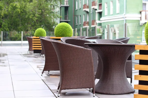 Wicker furniture in summer cafe on cinema terrace after rain — Stock Photo, Image