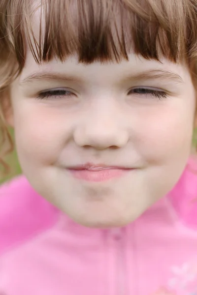 Close up de cara pequena menina sorridente feliz bonita em rosa — Fotografia de Stock